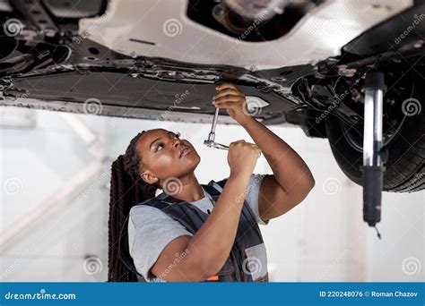 Woman Mechanic Filing Her Nails With Large Metal File Royalty Free