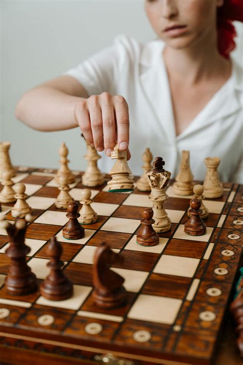 Person Playing Chess Game on Chess Board · Free Stock Photo