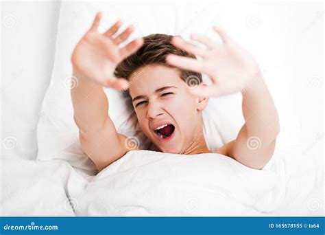 Happy Handsome Yawning Child Boy Lying Bed And Resting Stock Image