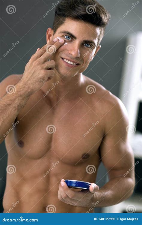 Handsome Man Applying Facial Cream Stock Image Image Of Cosmetology