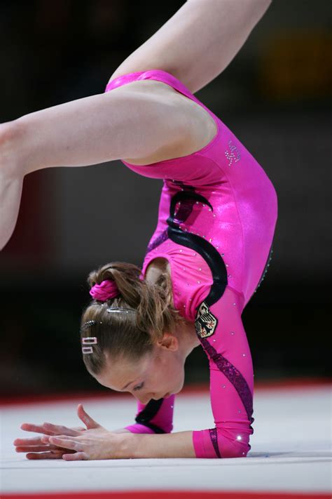 Woman Performing Handstand In Pink Outfit