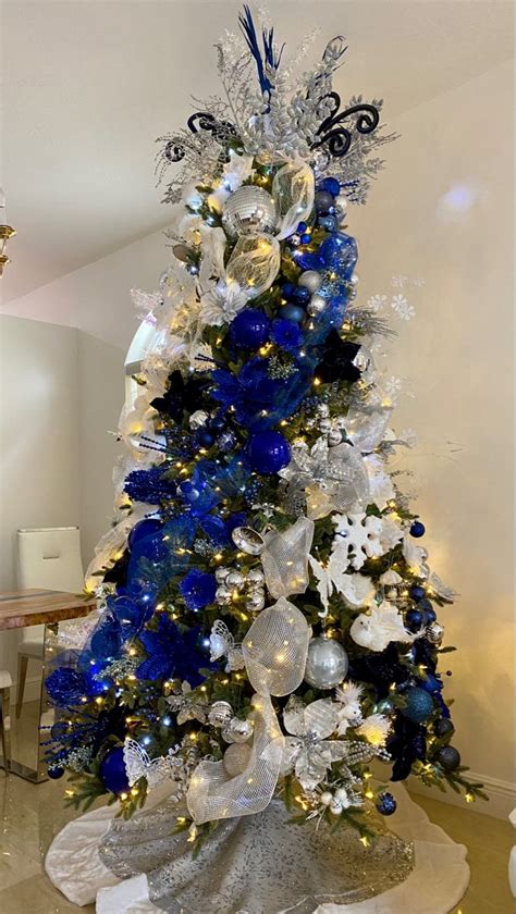 A Christmas Tree With Blue And Silver Decorations