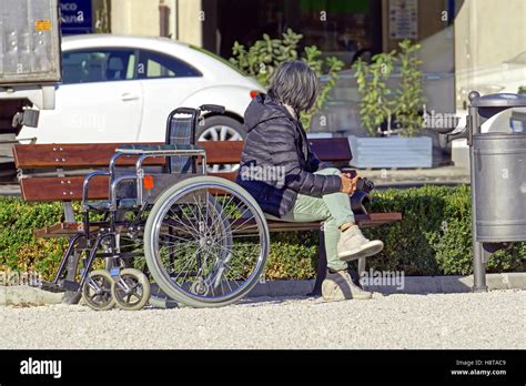 A Group Of People Sitting In The Public Square Stock Photo Alamy