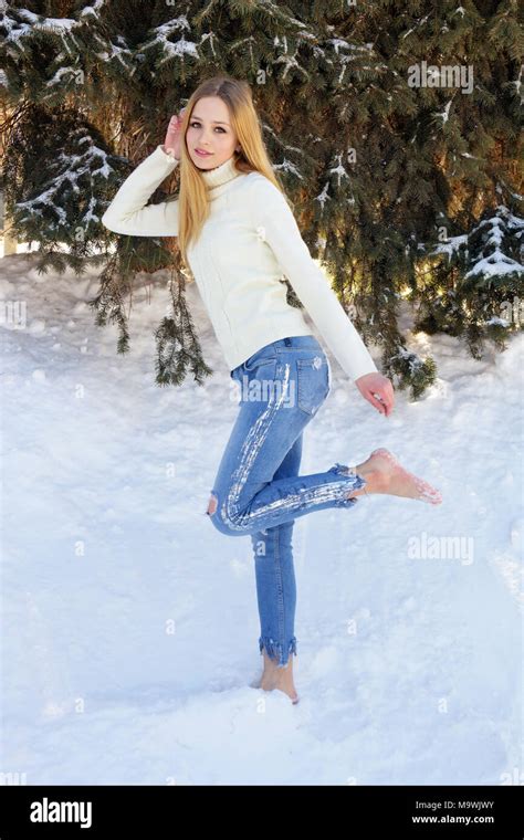 Cute beautiful teen girl posing barefoot in the snow in the Park Stock ...