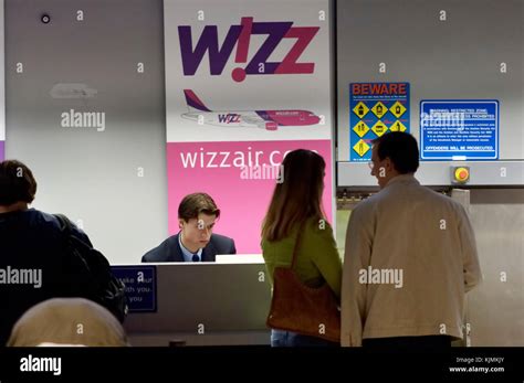 Wizzair check-in desks with warning posters Stock Photo - Alamy