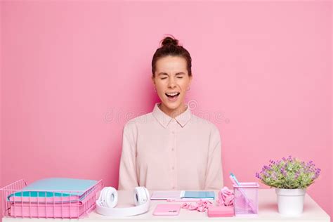 Brunette Woman Screams With Eyes Closed Seats At The Working Desk