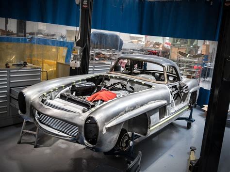 An Old Car Being Worked On In A Garage