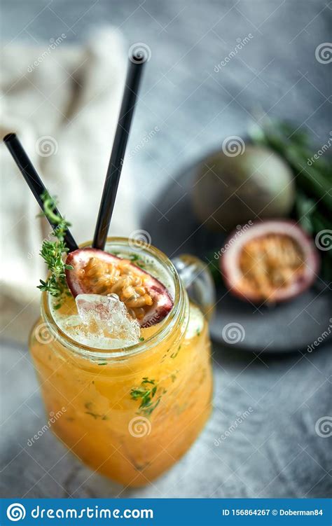 Tropical Cocktail With Passion Fruit Lime And Mint On A Gray