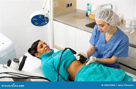 Cosmetologist Performing Ultrasound Cavitation Body Procedure For