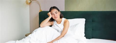 Free Photo Portrait Of Sad Young Woman Waking Up Feeling Bad Wants To Sleep Wakes Early