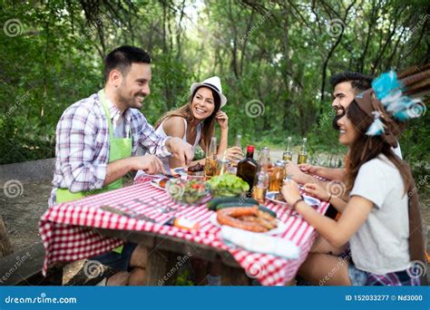 Friends Having A Barbecue Party In Nature While Having Fun Obraz Stock