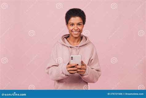 Smiling Attractive Black Girl Holding Smartphone In Her Hands And