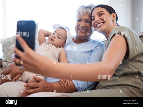 My Mums My Hero A Mature Woman Bonding With Her Daughter And Granddaughter On The Sofa Stock