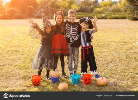 Cheerful friends celebrating Halloween in park Stock Photo by ©kegfire ...