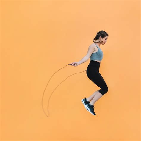 Premium Photo Fit Woman Jumping With Rope