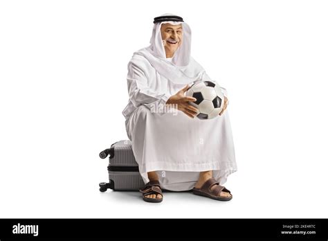 Smiling Mature Arab Man In Ethnic Clothes Sitting On A Suitcase And