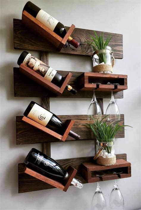 Three Wine Bottles And Two Glasses Are On The Wall Next To Each Other