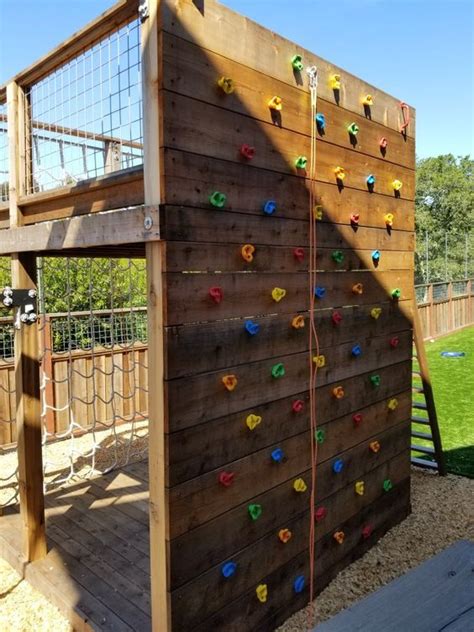 a backyard climbing wall including netting wall with a platform on top ...