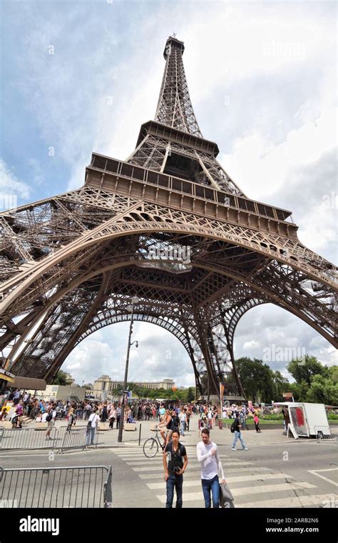 PARIS, FRANCE - JULY 25, 2011: People walk in front of Eiffel Tower in Paris, France. Eiffel ...