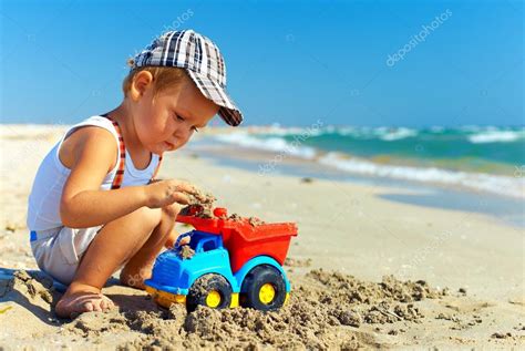 Cute Baby Boy Playing Toys On Beach Stock Photo By ©olesiabilkei 19722883