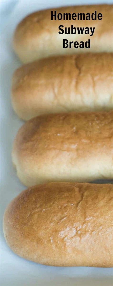 Four Loaves Of Bread Sitting On Top Of A White Tray With The Words