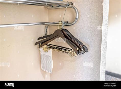 Closeup Of Closet Hangers In Empty Room On Pole Stand In Modern Hotel