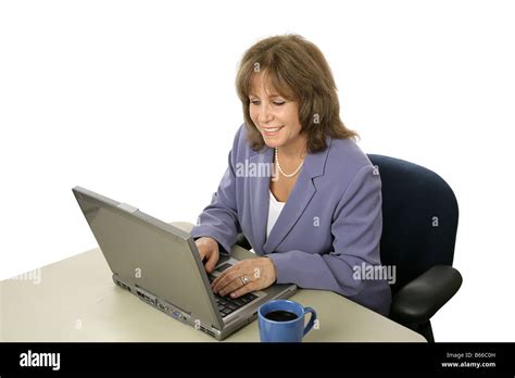 A Mature Female Executive Working On Her Laptop Computer Isolated On White Stock Photo Alamy