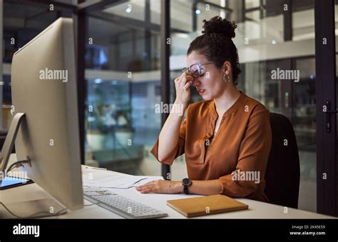 Stress Tired And Frustrated Business Woman Working On A Computer At The Desk In Her Office