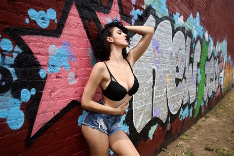 Wallpaper Women Model Brunette Urban Wall Arms Up Jean Shorts