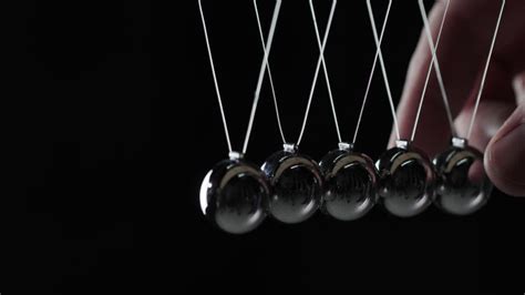 Premium Stock Video Balls In Newton S Cradle Hit Each Other