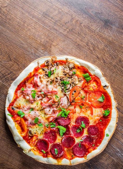 Pizza `four Seasons` With Mozzarella Cheese Ham Tomato Sauce Salami