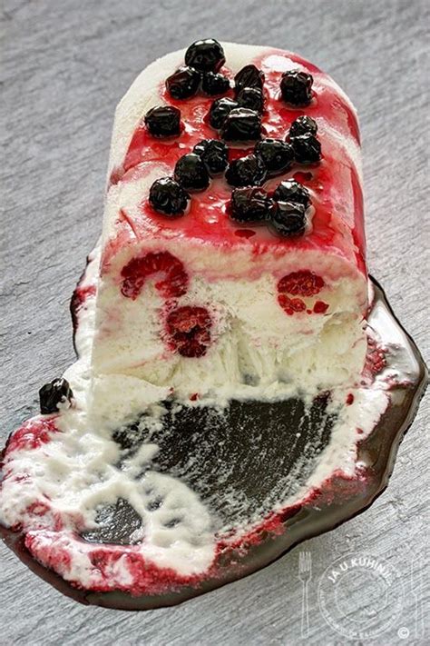 A Piece Of Cake With Berries And Cream On It