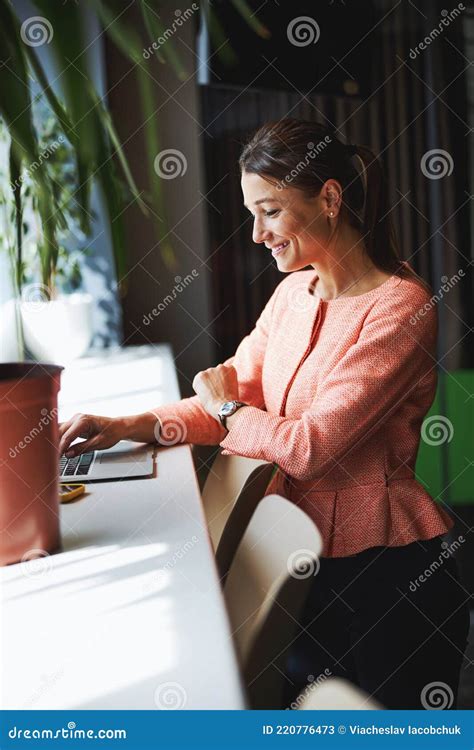 Happy Cheerful Caucasian Female Office Worker Is Smiling While Looking