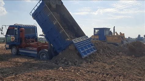 Land Filling Process Ton Dump Truck Unloading Dirt And Bulldozer