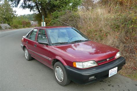 OLD PARKED CARS.: 1991 Geo PRIZM.