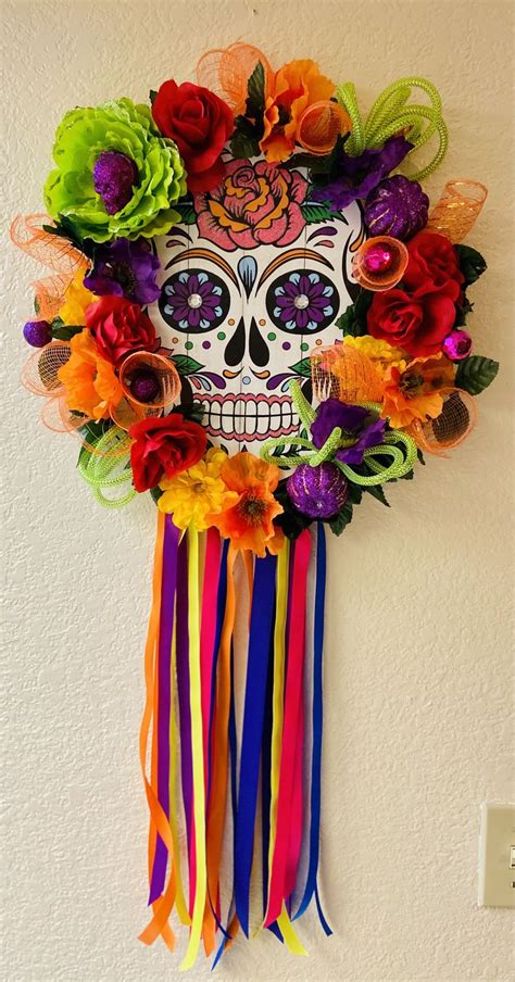 Decoración día de Muertos A Colorful Skull Mask Hanging on the Wall