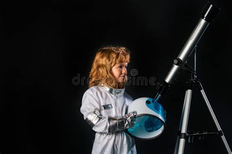 A Little Boy With Telescope And Space Helmet Dreams Of Becoming An