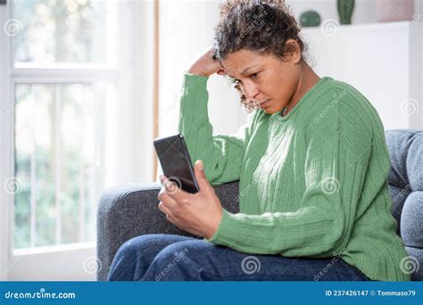 Worried Black Woman Getting Bad News On Mobile Phone Stock Image