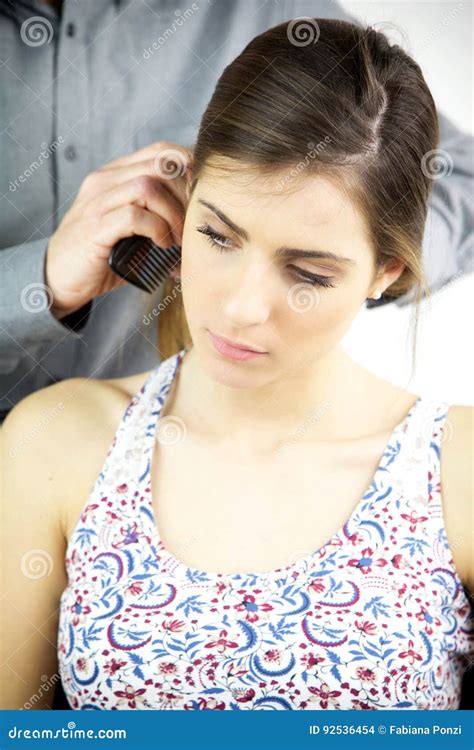 Beautiful Female Model Getting Hair Combed By Hairdresser Stock Photo