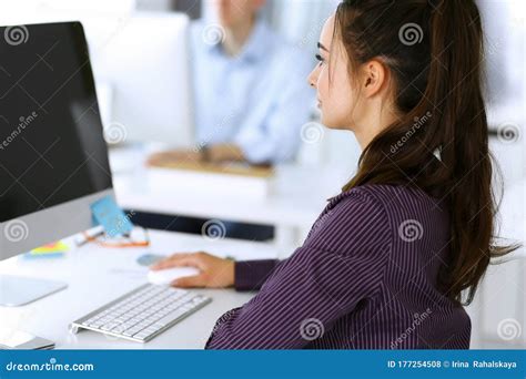 Business Woman Using Computer At Workplace In Modern Office Brunette