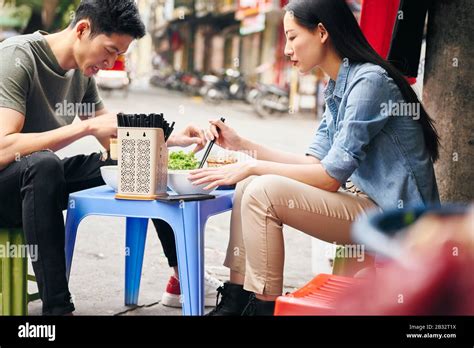 Tourists Eating Street Food In Vietnam Stock Photo Alamy