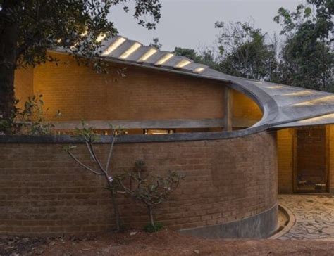 Twisting Rammed Earth Home Wraps Around A Grand Jackfruit Tree