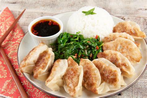 Chinese New Year Dim Sum Pork Dumplings With Spicy Sesame Spinach And