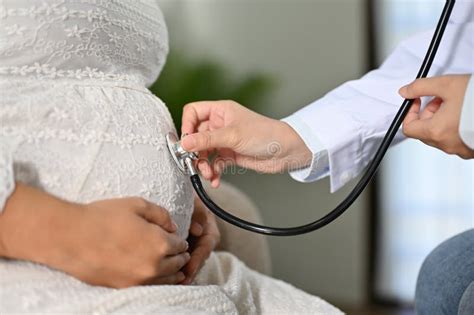 Female Doctor Using A Stethoscope To Listen To The Baby S Heartbeat In