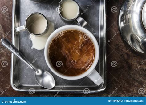 Two Asian Coffee Waitress Making Cup Of Hot Coffee Latte In Coffee Shop