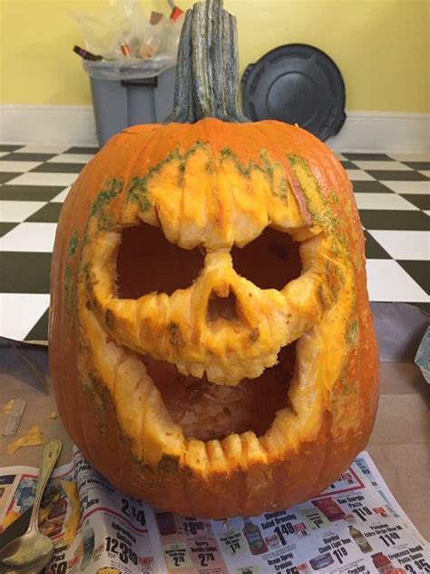 A Carved Pumpkin Sitting On Top Of A Table