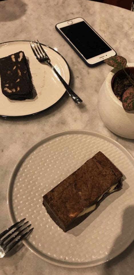 There Is A Piece Of Chocolate Cake On The Plate Next To A Fork And Knife