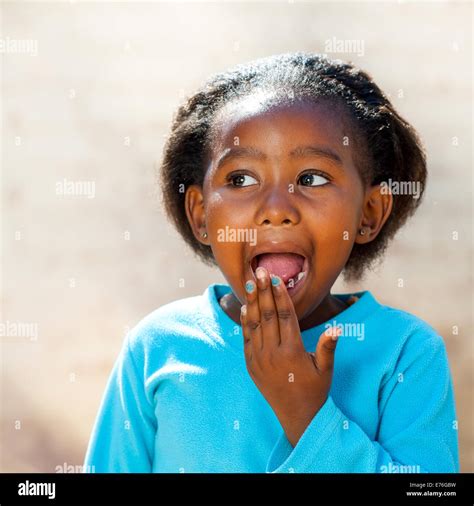 Close up portrait of little African girl with surprised face expression ...