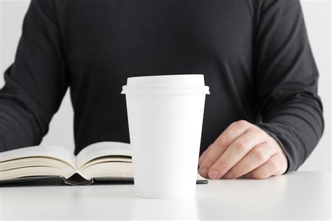 Premium Photo White Coffee Paper Cup Mockup With Man Reading A Book