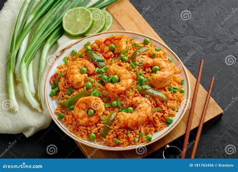 Thai Tom Yum Fried Rice Or Prawn Biryani In White Plate On Black Slate